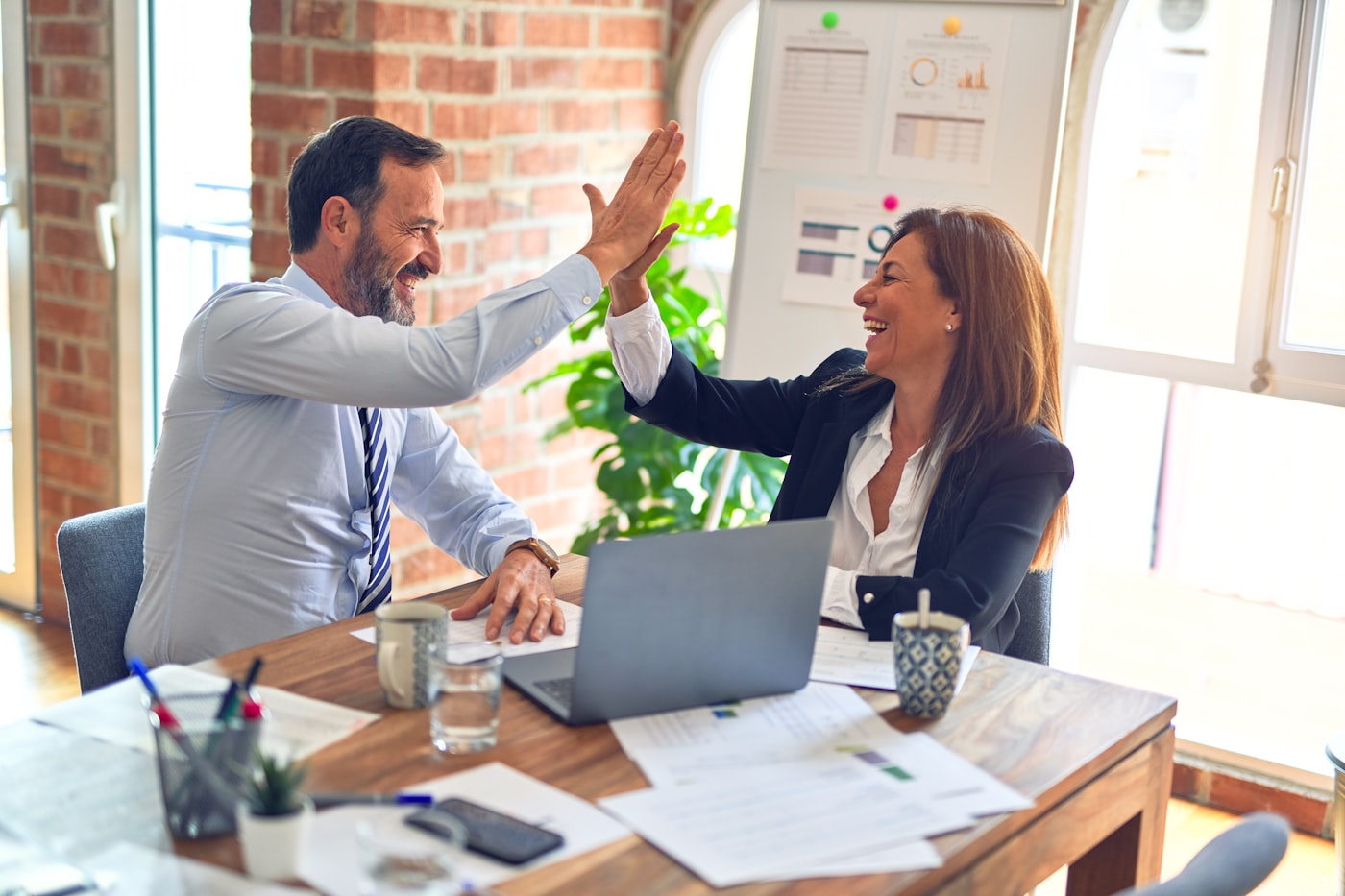 A business owner and an advisor reviewing benefits together at a table