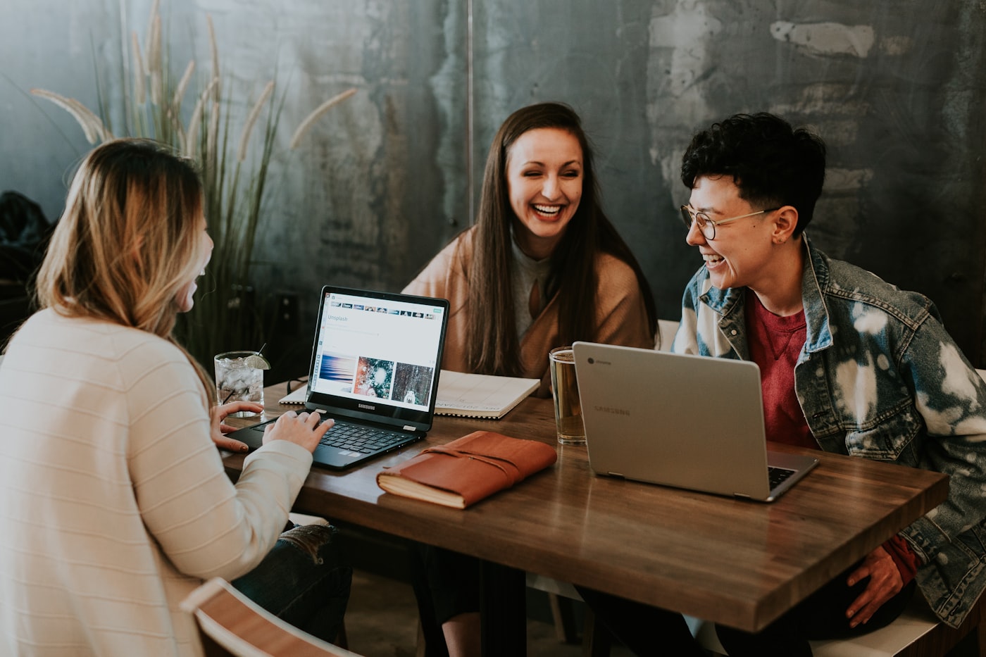 A small team collaborating around a table in a bright workspace